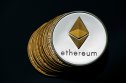 Representation of a silver Ethereum (ETH) token on a pile of bitcoins