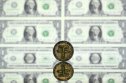 Tether An illustration picture taken in London on 8 May, 2022, shows a gold plated souvenir cryptocurrency Tether (USDT) coin arranged beside a screen displaying US dollar notes
