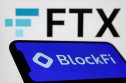 BlockFi BlockFi name and logo displayed on a phone with the FTX logo behind on a laptop screen