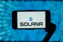 Solana (SOL) The Solana (SOL) logo is displayed on a smartphone