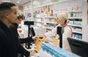 Walgreens dividend cut (WBA) people shopping at a pharmacy