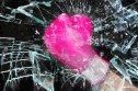 Photo of pink boxing glove breaking glass
