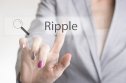 Female hand touching screen with Ripple showing on it