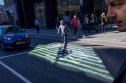 The Bank of England has delayed a 'full assessment' of the UK's new economic policy, undermining sterling's direction A man crosses Threadneedle Street in front of stopped traffic