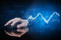 Top energy tokens Hand using wireless mouse with statistical concept on dark background