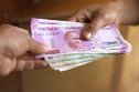 Stack of Indian rupees Small stack of Indian rupee notes changing hands