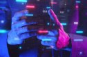 Sandbox (SAND) price prediction Person using a smartphone bathed in blue and purple light