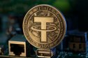 what is Tether Tether USDT cryptocurrency physical coin placed on microscheme in the dark background. Selective focus.