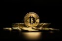 Can bitcoin cross the $1m threshold? Rendering of physical bitcoin tokens on black background