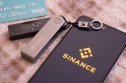 Binance logo on the screen smartphone and Ledger nano X Wallet. Binance - one of the largest cryptocurrency exchange on the market. Caserta, Italy - March 23th, 2021