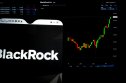 BlackRock Inc. logo displayed on a smartphone with BlackRock Inc. stock chart in the background.