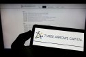 Three Arrows Capital Person holding smartphone with logo of Three Arrows Capital
