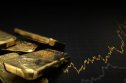 Gold price predictions Gold bars on a black background with a diagram