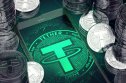tether short interest A smartphone with a green Tether symbol on the screen among the Tether coins.