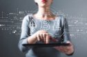 women in front of glass with computer