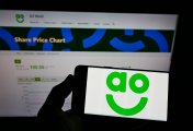 AO logo on phone in front of web page. Photo: Shutterstock AO logo on phone in front of web page. Photo: Shutterstock