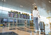 stock market woman at airport looking at timings