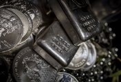 Silver bullion Silver bullion and coins on a dark background