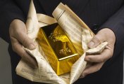 Gold bar A man holding a gold bar in a newspaper