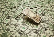 USD JPY Yen bill on a stack of dollars