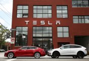 TSLA, BYD, RIVN, Electric Vehicles Tesla cars parked in front of Tesla office