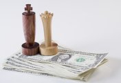 USD Dollar bills with a king and queen chess piece on them