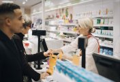 Walgreens dividend cut (WBA) people shopping at a pharmacy