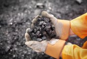 Are mining stocks looking cheap after a China sell off? Coal worker with handful of coal