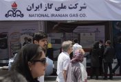 NIGC Visitors walk past a stand of the National Iranian Gas Company (NIGC) at the 26th International Oil, Gas, Refining and Petrochemical Exhibition in Tehran, in May 2022.