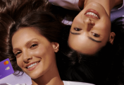Nu Holdings Promotional image of two consumers holding a Nu Holdings card