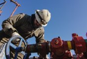 US Drilling Site An oilfield worker pumps down lines at an oil and gas drilling pad in the US.