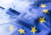 Euro market holds up Eurozone flag and euro notes