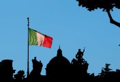 Is the 'Club Med' debt crisis back – and how soon might it dig into the euro's trajectory? Italian flag flying in late afternoon sunshine