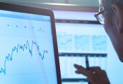 Analyst earnings estimates still too high despite recent cuts Man reading graphs on computer screen
