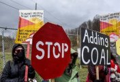 People hold signs as they protest against U.S. Senator Joe Manchin (D-WV) as they blockade the Grant Town Coal Waste Power Plant in Grant Town, West Virginia, U.S., April 9, 2022. People hold signs as they protest against U.S. Senator Joe Manchin (D-WV) as they blockade the Grant Town Coal Waste Power Plant in Grant Town, West Virginia, U.S., April 9, 2022.