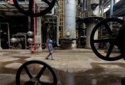 A file photo of a worker walking past oil pipes at a refinery in Wuhan, Hubei province March 23, 2012. A file photo of a worker walking past oil pipes at a refinery in Wuhan, Hubei province March 23, 2012.