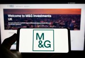 M&G A image of Person holding smartphone with logo of British investment company M&G plc (MG)