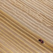 A file photo shows an aerial view of a French farmer in his tractor making bales of straw in a field in Coquelles,France, July 21, 2015. 