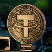 what is Tether Tether USDT cryptocurrency physical coin placed on microscheme in the dark background. Selective focus.