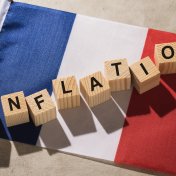 Flag of France and wooden cubes with text, concept on the theme of inflation in the country