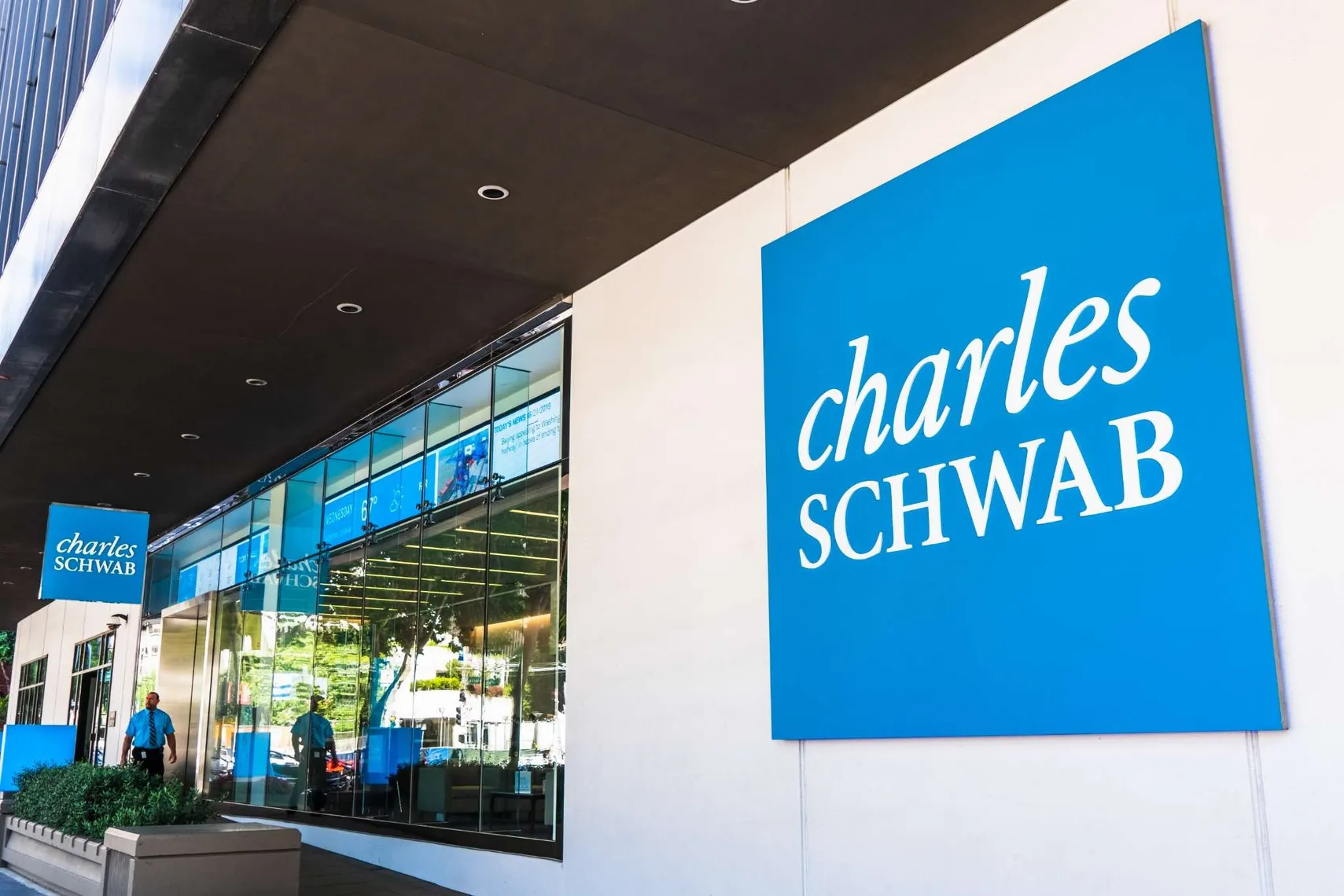 Charles Schwab Stock Forecast 2025–2030 | Future Outlook Charles Schwab office and logo in blue