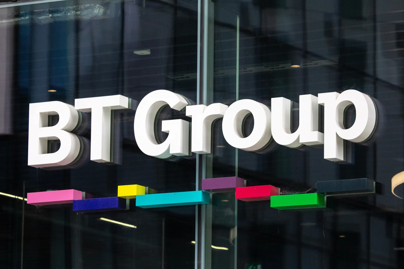BT Group logo displayed on the exterior of a building. BT Group logo displayed on the exterior of a building.