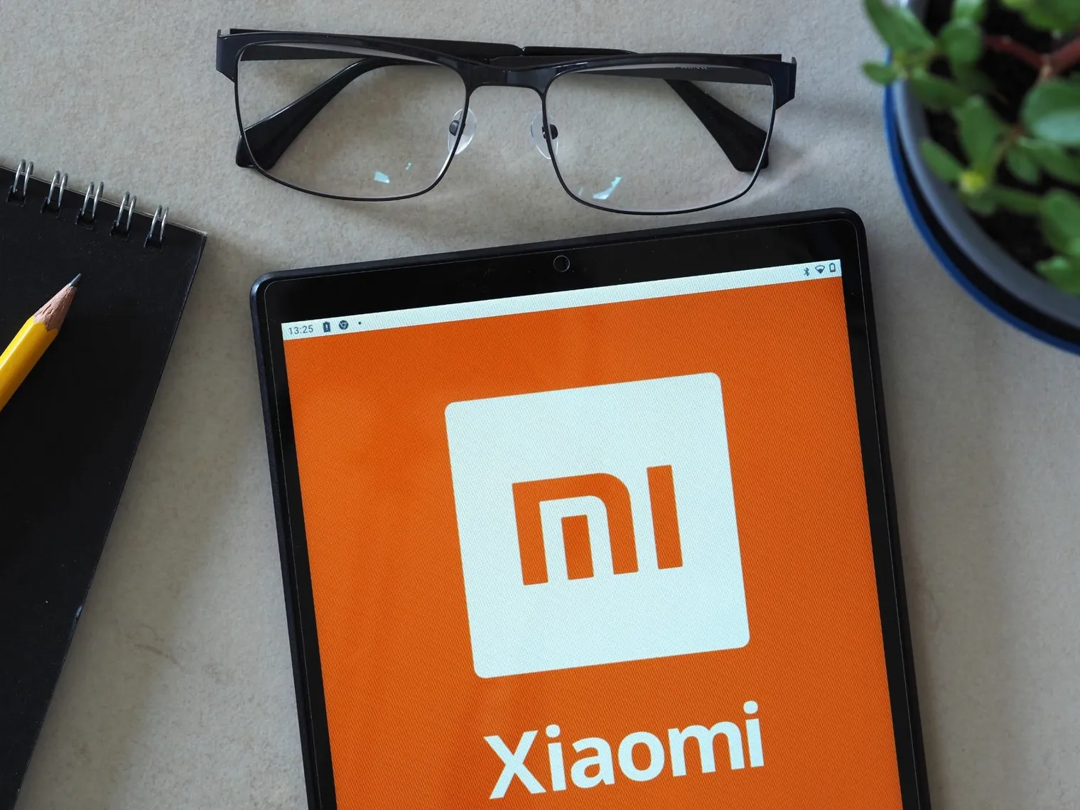 Xiaomi logo on a tablet device, representing the global consumer electronics and smartphone brand Xiaomi logo on a tablet device, representing the global consumer electronics and smartphone brand