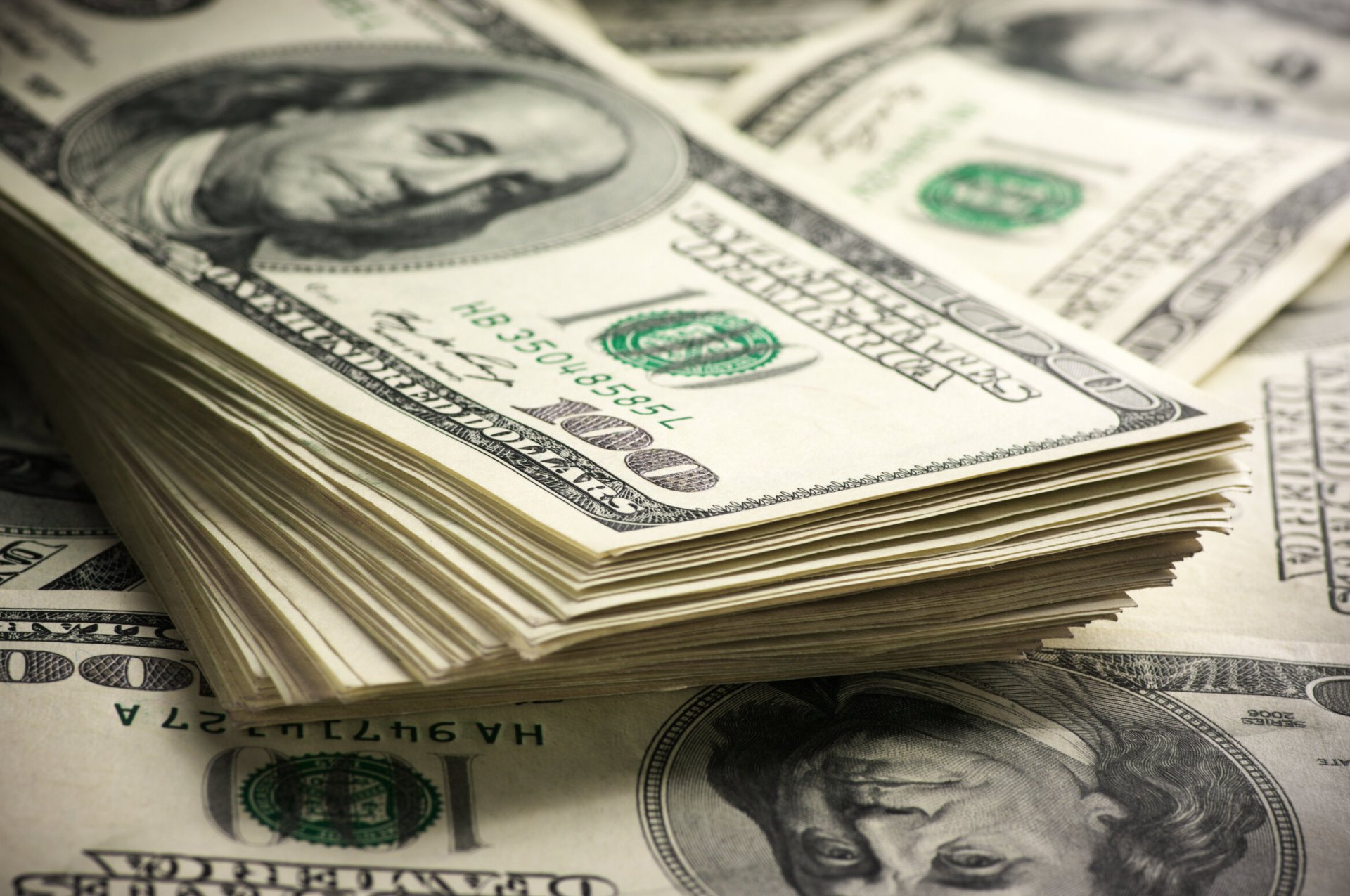  Stack of one hundred dollar bills close-up.