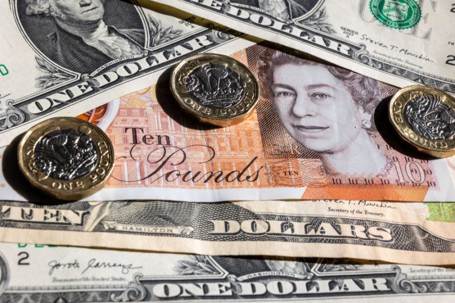 GBP/USD forecast: How low can the pair go? US dollar bills with British £1 coins and notes