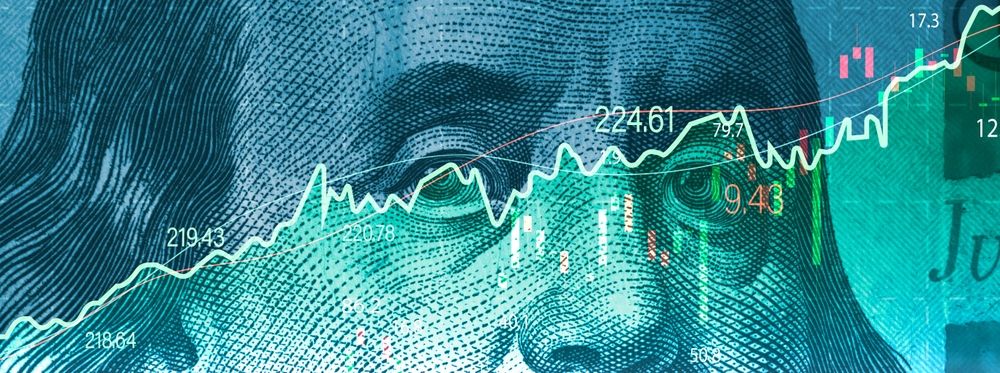 Closeup Benjamin Franklin face on USD banknote with stock market chart graph for currency exchange and global trade forex concept. Closeup Benjamin Franklin face on USD banknote with stock market chart graph for currency exchange and global trade forex concept.