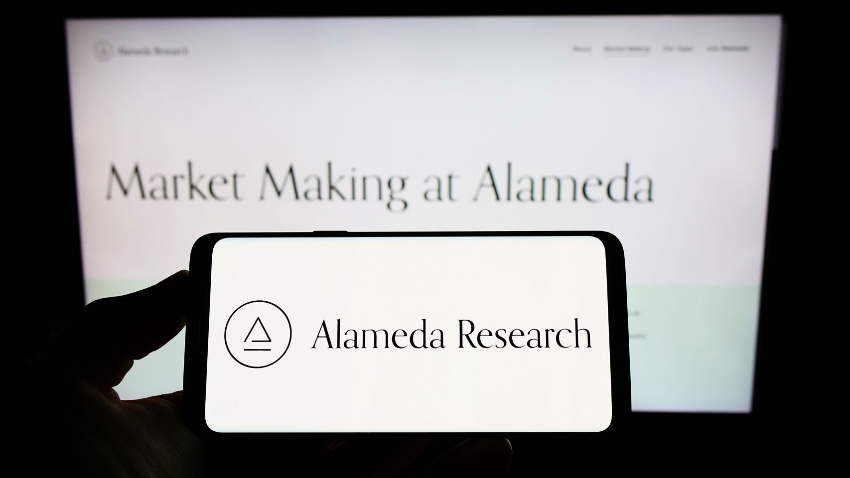 Alameda Research Alameda Research logo on smartphone and computer screen