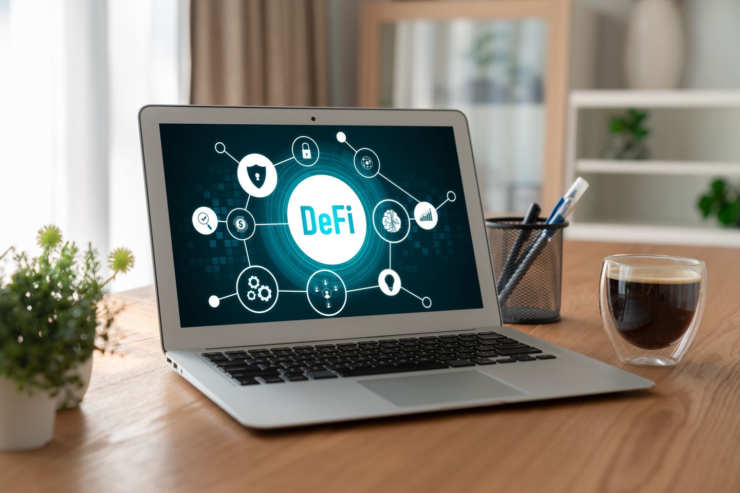 A laptop features an illustration explaining decentralised finance (DeFI)