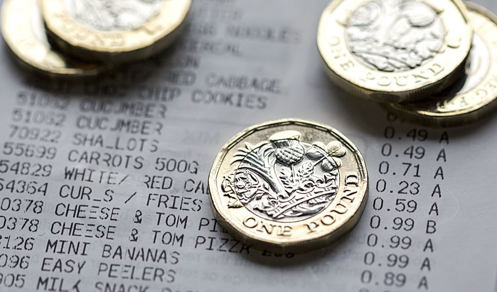 One Pound Coins on a Till Receipt One Pound Coins on a Till Receipt