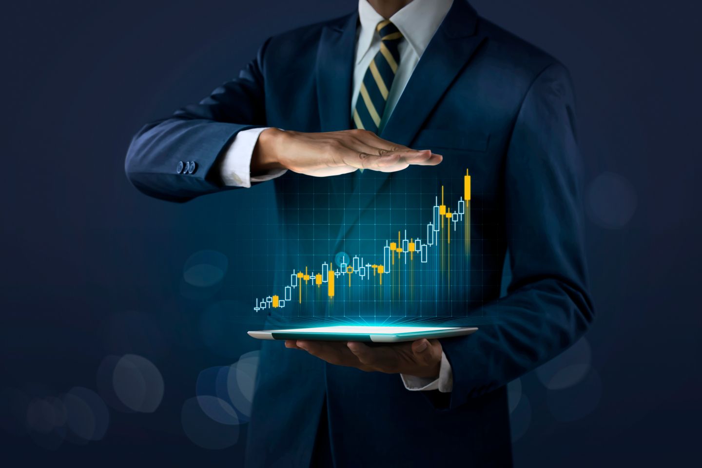 S&P 500 vs US Tech 100: Recession outlook The concept of business growth, progress or success. A businessman shows a growing stock of a virtual hologram on a dark background.